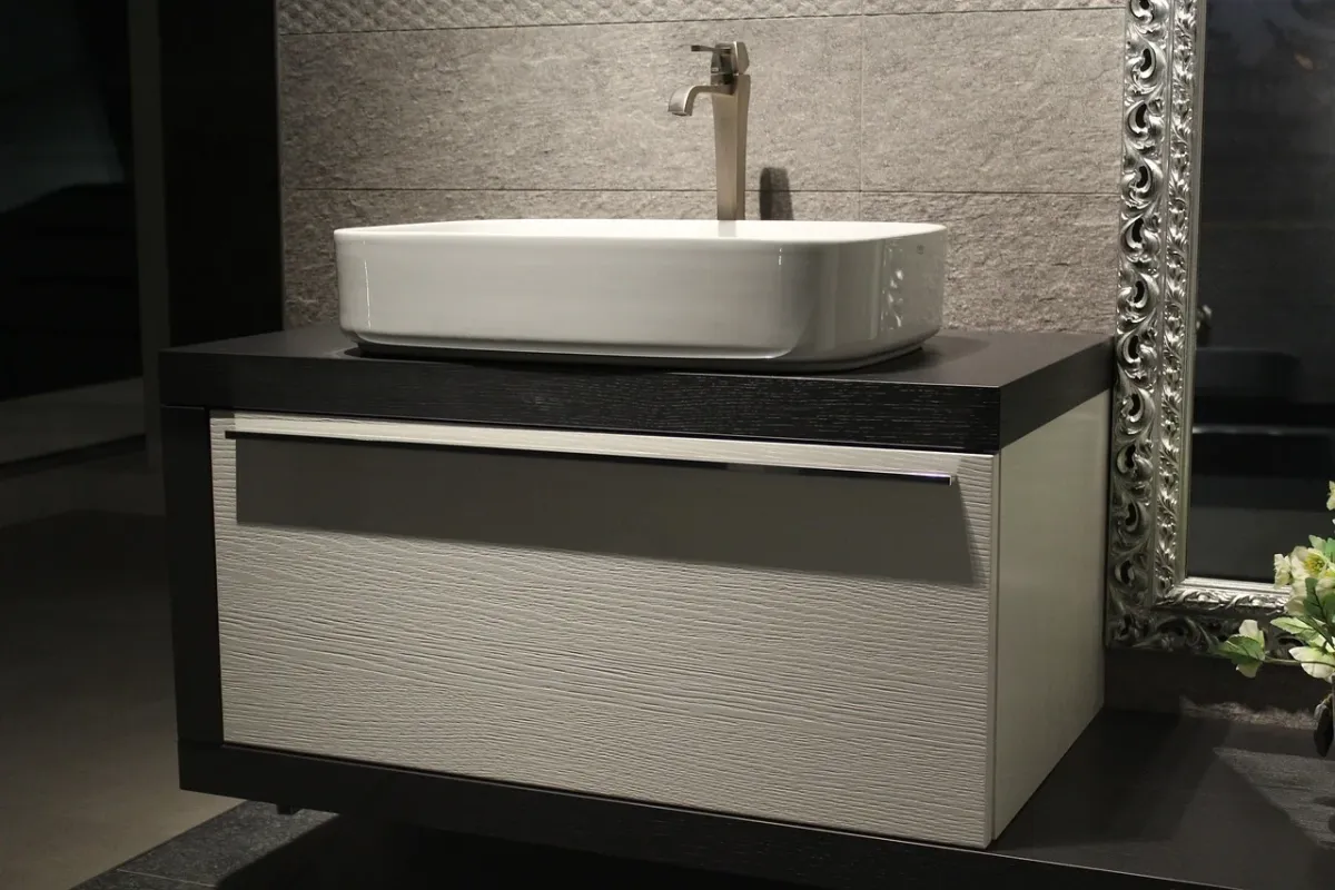 Nowoczesna bateria łazienkowa zamontowana na umywalce w szafce podumywalkowej.
